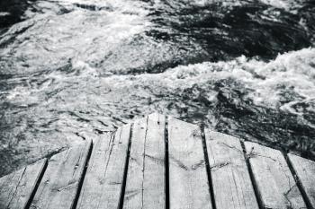Corner of an old wooden pier, black and white photo