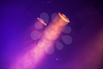 Spot lights with purple rays in the dark, stage illumination equipment