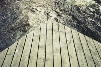 Corner of an old wooden pier, vintage green toned photo, old instagram style effect