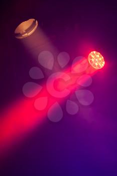 Stage spot lights with smoke in beams, stage illumination equipment, vertical photo
