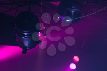 Scenic spot light over dark purple beams, stage illumination equipment