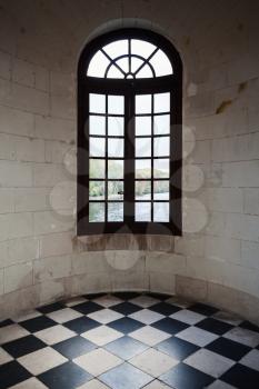 Abstract ancient interior fragment. Window in round wall, shining floor tiling with checkered pattern