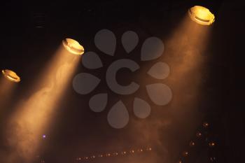 Scenic spot lights with bright beams in smoke, stage illumination