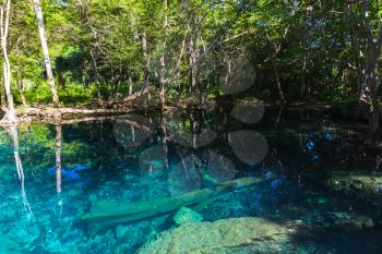 Blue lake in dark tropical forest, natural landscape of Dominican Republic