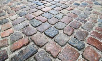 Old dark colorful shining cobblestone road background photo