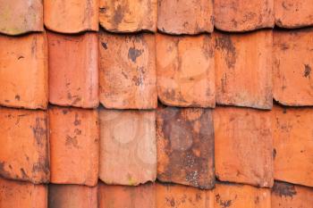 Vintage red roof tiling, close-up frontal background photo texture