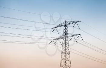 Transmission power tower, electricity pylon over sky background. Steel lattice tower, used to support an overhead power line