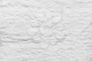 Rough concrete wall with white plaster layer pattern, background photo texture