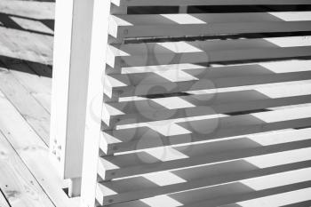 Abstract wooden architecture fragment, white railings corner made of planks. Closeup photo with selective focus