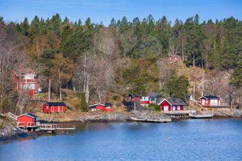 Swedish rural landscape, coastal village with red wooden houses and barns