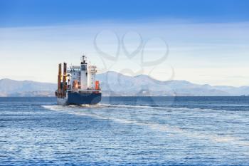 Container ship goes on Norwegian sea, rear view, Trondheim region