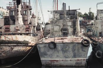 Old rusted gray industrial ships, stern view, vintage tonal correction filter effect