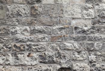 Old grungy gray brick wall, closeup flat background photo texture
