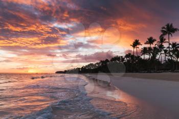 Colorful tropical sunrise over Atlantic Ocean coast, Bavaro beach, Hispaniola Island. Dominican Republic, coastal landscape