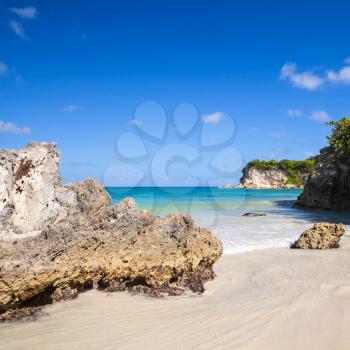 Coastal rocks and sand of Macao Beach, touristic resort of Dominican Republic, Hispaniola Island. Square natural photo