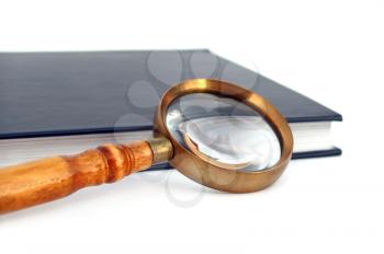 Old style magnifying glass isolated on white