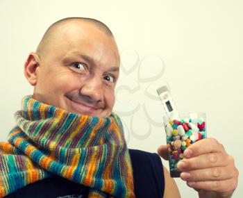 Happy man drinking cocktail of colorful pills