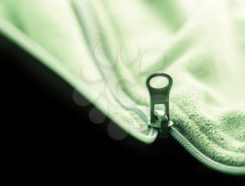 Closeup of zipper opening green fleece jacket
