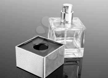 Bottle of fashion perfume on grey surface