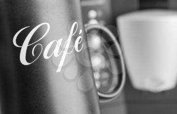 Close-up of cup with coffee machine on background