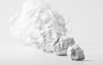 Concept of crumpled paper balls on white