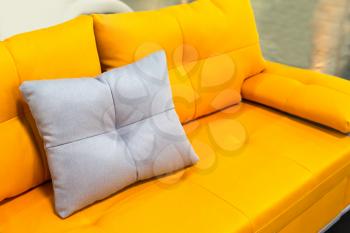 Yellow sofa with white pillow