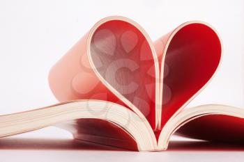 Red book pages folded into a heart shape closeup