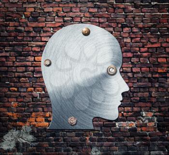 One metal silhouette of human head on brick wall