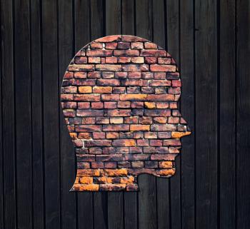 Light in form of silhouette of human head on wooden wall