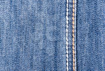 Close-up of blue jeans background with seam