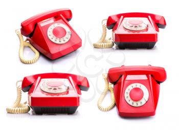 Set of vintage red telephones isolated over white background