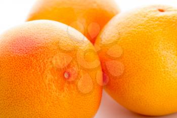 Three round oranges. Close-up photo. Fresh fruit.