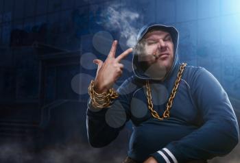 Angry man, sitting with a cigarette in dark appartment