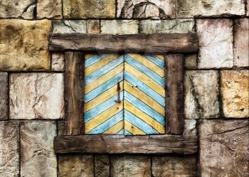 Old window on ancient stone wall