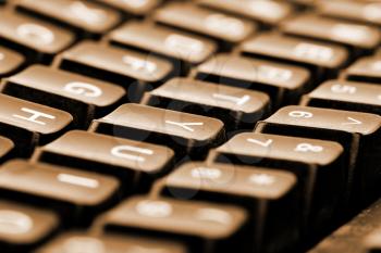 Close-up of computer keyboard. Toned in sepia