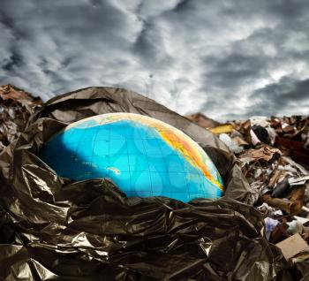 Earth contamination concept. Litter and dramatic sky