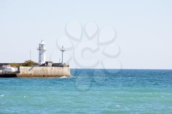 Coastline lighthouse in harbor. Ukraine, Yalta