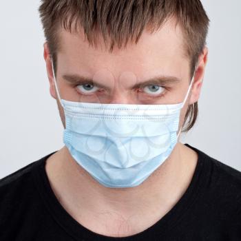 Portrait of pensive young man in medical mask