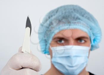 Portrait of serious surgeon with surgical knife