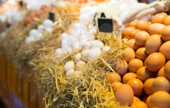 Fresh farm eggs on a straw in market