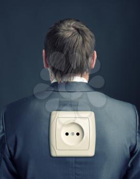 Businessman with electrical outlet on back