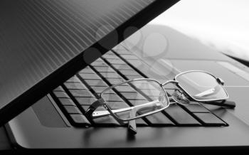 Businessman's glasses on laptop computer