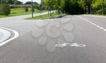 Modern asphalt track for cyclists near green park