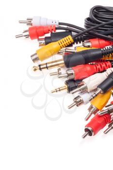 Closeup of set of many audio and video cables isolated on white