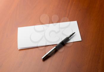 Closed letter and pen on a wooden table closeup