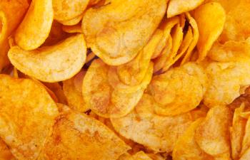 Close-up of fried potato chips. Background or texture