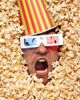 Surprised face in popcorn with bucket on head watching 3D movie