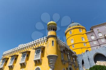Beautiful yellow castle with towers against the sky