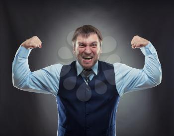 Crazy businessman shows his muscles