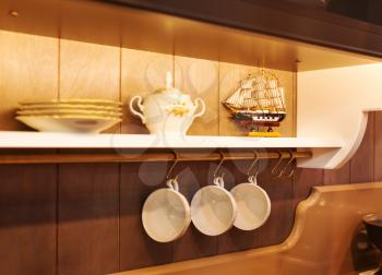 Closeup photo of white plates and dinnerware in a cupboard